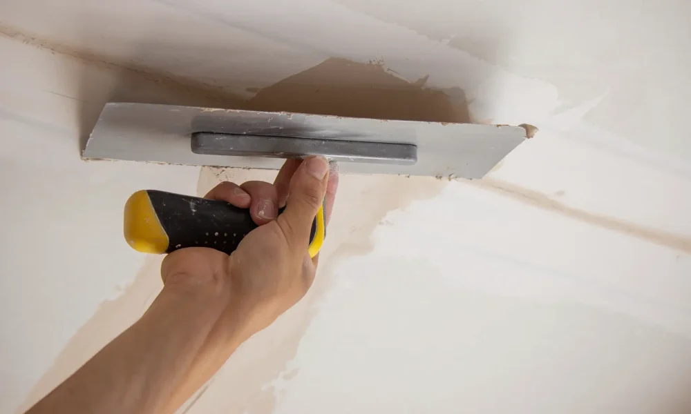 arm-smoothing-plaster-on-wall-with-trowel-2026-03-24-16-48-34-utc